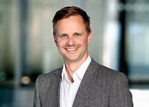 "Vidar Fiskum står på scen och talar inför publik."